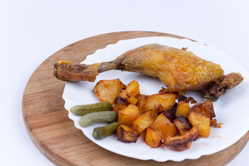 Fried chicken meat with potatoes in the plate