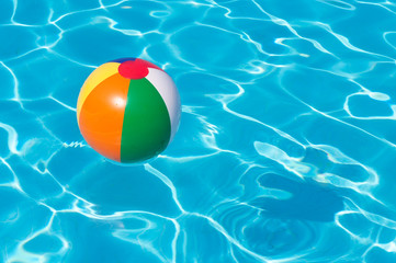 Colorful beach ball floating in a pool
