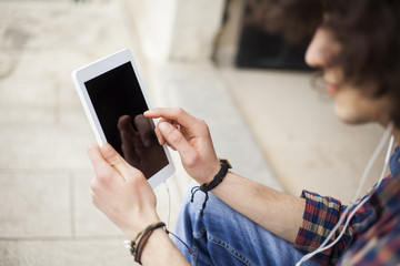 Young man using digital tablet