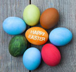 Easter eggs in nest on rustic wooden background, selective focus image, Card Happy Easter - space for text