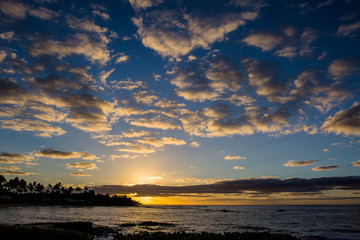 Dramatic clouds and sunrise over Poipu Beach