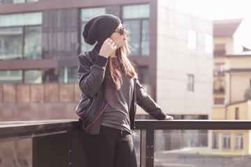 Fototapeta premium Young woman listening to music