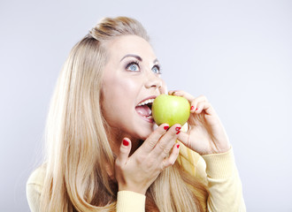 Smiling girl with green apple. Broad smile. Healthy teeth
