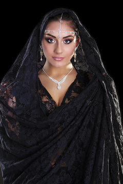 Portrait of a beautiful woman with arabian makeup in black paran