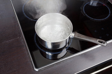 Dipper of water on the kitchen stove