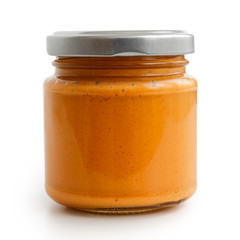 Closed glass jar of tomato and red chilli pepper salsa. Isolated.