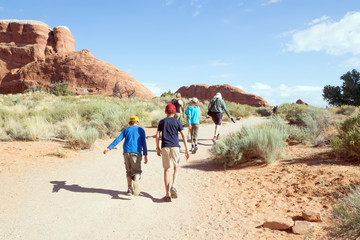 Family with children walking along the trail in Arches National