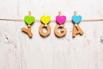 the word "yoga" from the wooden letters on a white background ol