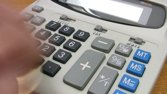 Fast operation of an adding machine or office business calculator. Time lapse. Money and finance.