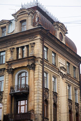 Fototapeta na wymiar Facade of old corner house with balconies