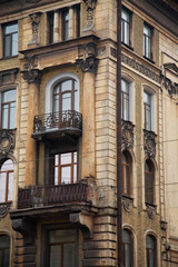 Fototapeta na wymiar Facade of old corner house with balconies