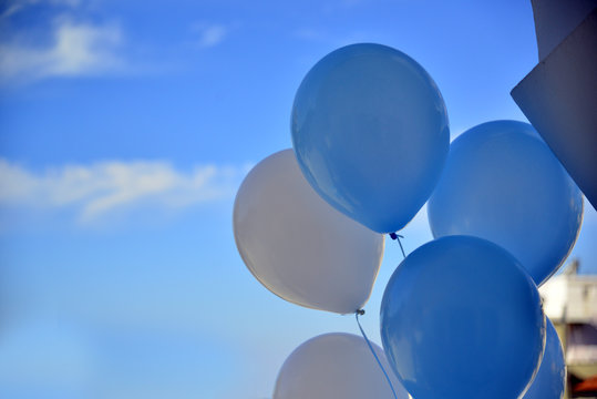 Blue balloons in a blue sky