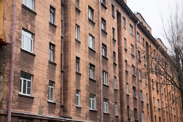 Facade of a multi-storey old house with windows