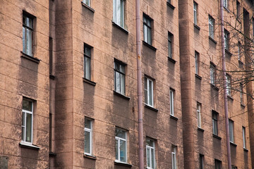 Fototapeta premium Facade of a multi-storey old house with windows