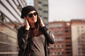Fototapeta premium Young woman listening to music