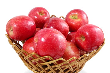 red apple in bamboo basket on white background