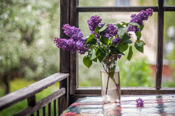 Bouquet of lilac on a rural terrace.