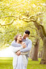 Fototapeta premium Young couple walking, Hyde Park, London: sunset colour tone