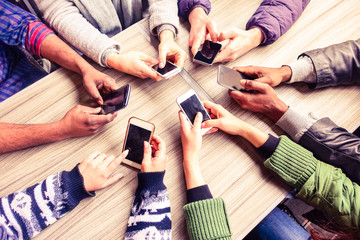 Top view hands circle using phone in cafe - Multiracial friends mobile addicted interior scene from...