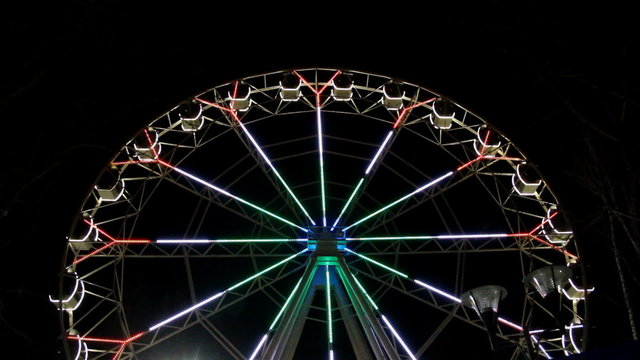 Big colourful illuminated ferris wheel at night in Ufa city