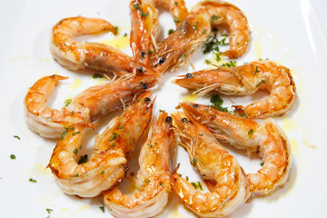 delicious cooked prawn plate served with olive oil on white background