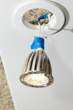 LED light bulb hangs from spot on wires