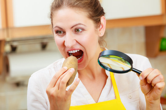 Woman With Magnifying Glass Eating Potato.