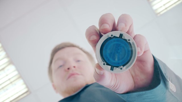 Businessman puts print stamp on office glass table. shoot from below