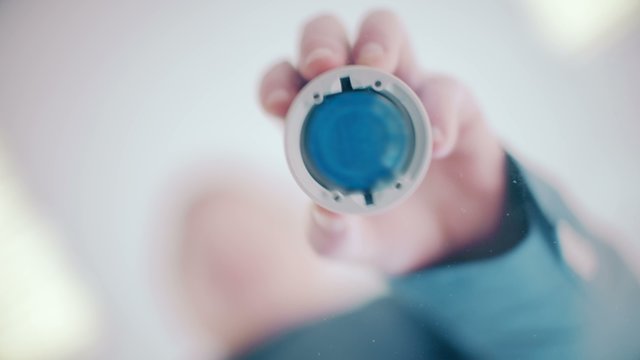 Businessman puts print stamp on office glass table. shoot from below