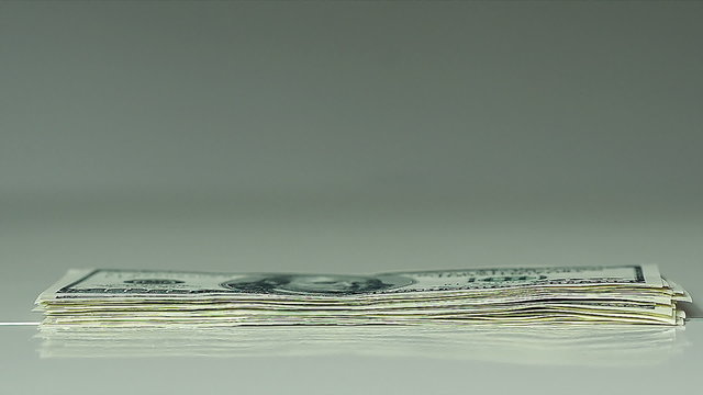 Closeup of a Male Hands Count Hundred Dollar Bills at a Table Fast