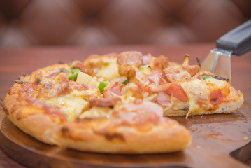 Selective Focus On Meat Deluxe Pizza Slice On Pizza Scoop