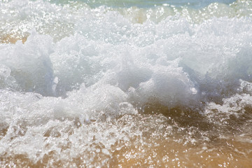 Wave splashes on sunny day