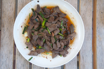 Stir fried pork liver on white plate. Homemade