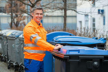 Working Man Standing Near Dustbin On Street
