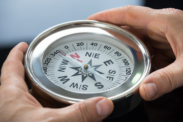 Close-up Of Person Hand With Compass