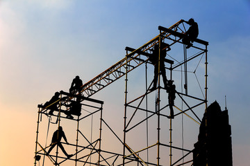 Silhouette of workmen in mounting the outdoor concert stage