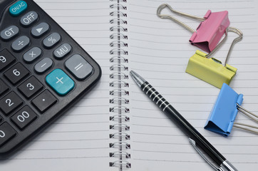 Calculator , pen and book