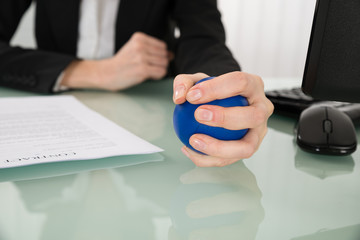 Close-up Of Businesswoman Pressing Stressball
