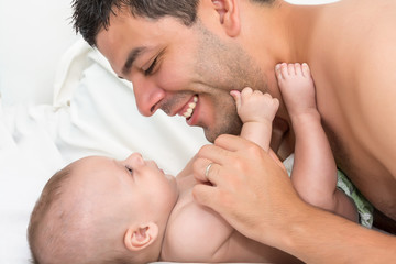 Father is playing with his baby