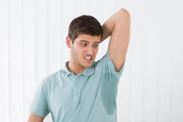 Obraz premium Man Sweating Very Badly Under Armpit