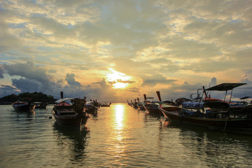 Fototapeta premium Boats on shore with sunset background