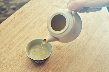 Old-style  kettle and Chinese glasses tea on the wood table