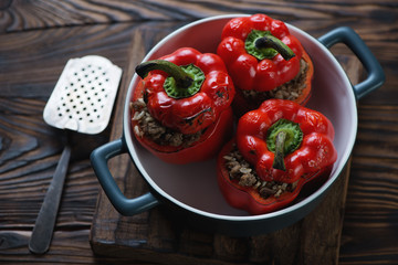 Bell peppers stuffed with beef meat and rice in a baking dish