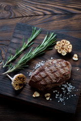Rustic wooden serving board with grilled asado beefsteak