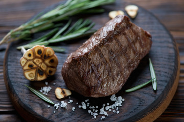 Grilled asado steak with garlic, sea salt and rosemary, close-up