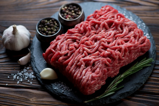 Close-up of raw fresh ground beef meat on a stone slate plate