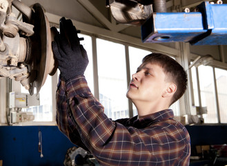 Car mechanic working in auto repair service