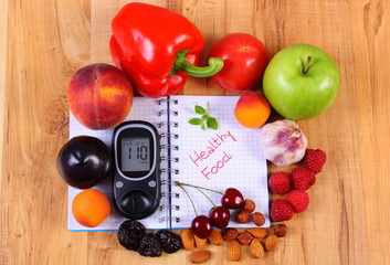 Fruits and vegetables with glucometer and notebook for notes, healthy food, diabetes