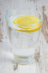 Glass of clean water with slice of lemon, cold lemonade