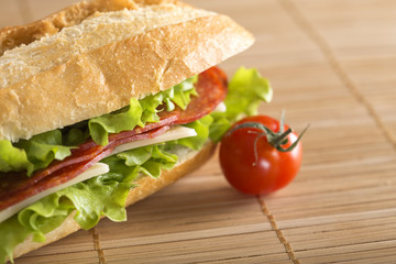 Sandwich with salami, cheese and lettuce